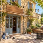 George Clooney Italian restaurant in Cotignac: a Provencal village storefront under renovation on a sunny street