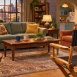 NBC's "Newlyweds" Fires Co-Creator Gail Lerner as Showrunner Two Weeks Before Premiere Editorial illustration of a sitcom living room with wedding rings and an empty director's chair. It is not a scene from the show.
