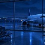 Selma Blair Taken Into Custody at JFK After Alleged Incident on Delta Flight, Rep Cites Medical Emergency Editorial illustration of an airport gate at night. Not the actual flight or anyone involved.