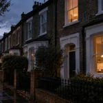 Slow Horses Season 6 Ending Explained: Is River Dead? 648 Illustration of a London terraced house at dusk with one upstairs light on and wine glasses in the kitchen window, for the Slow Horses Season 6 ending explained